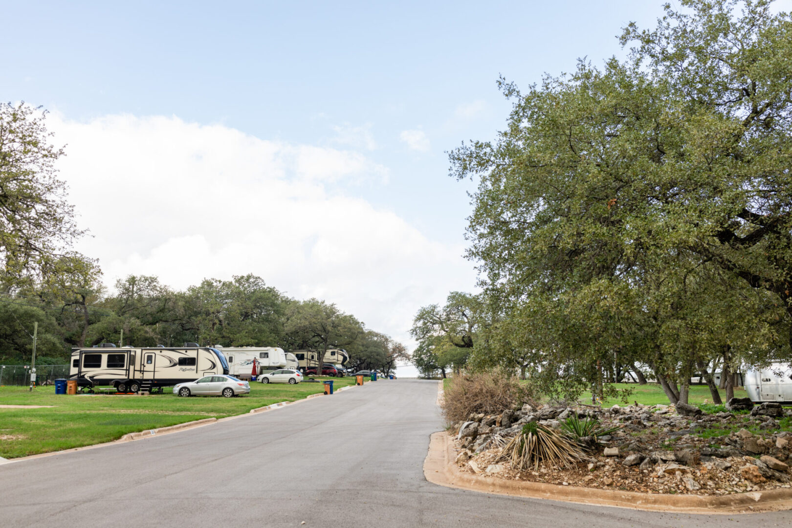 an empty road and moving homes parked beside