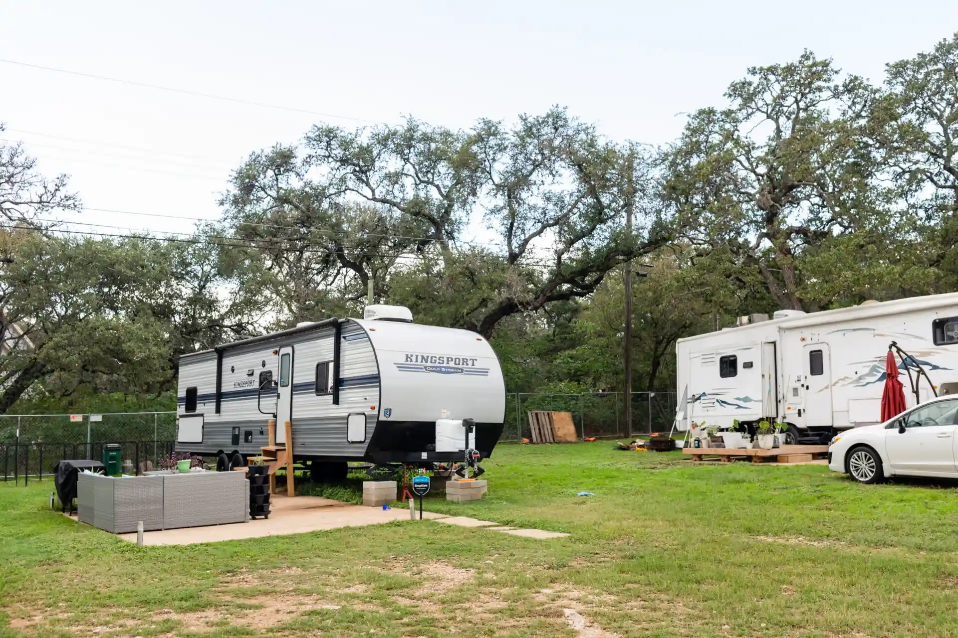 an RV van and a car at the mobile home park