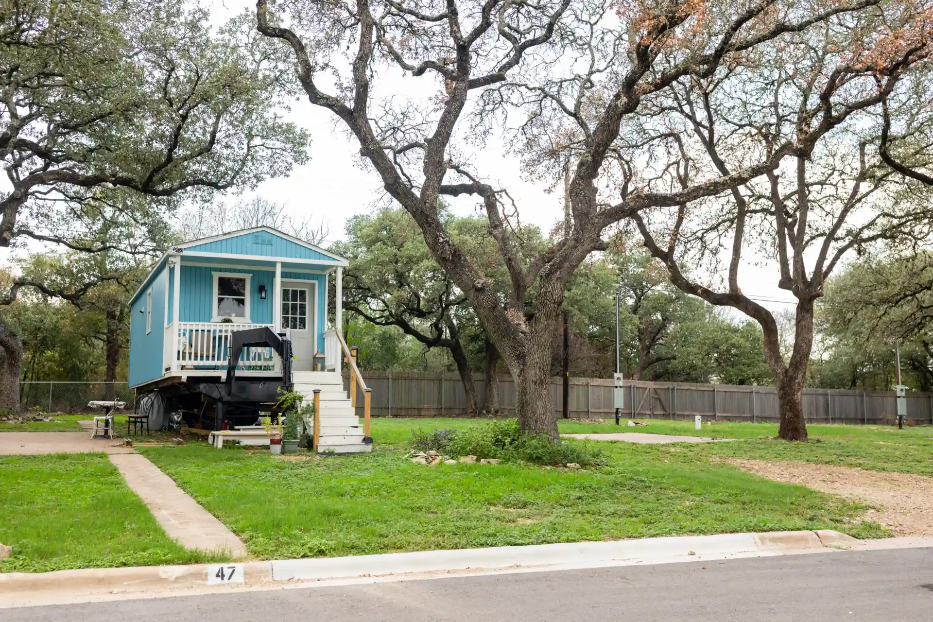 a sky blue color moving house and two trees