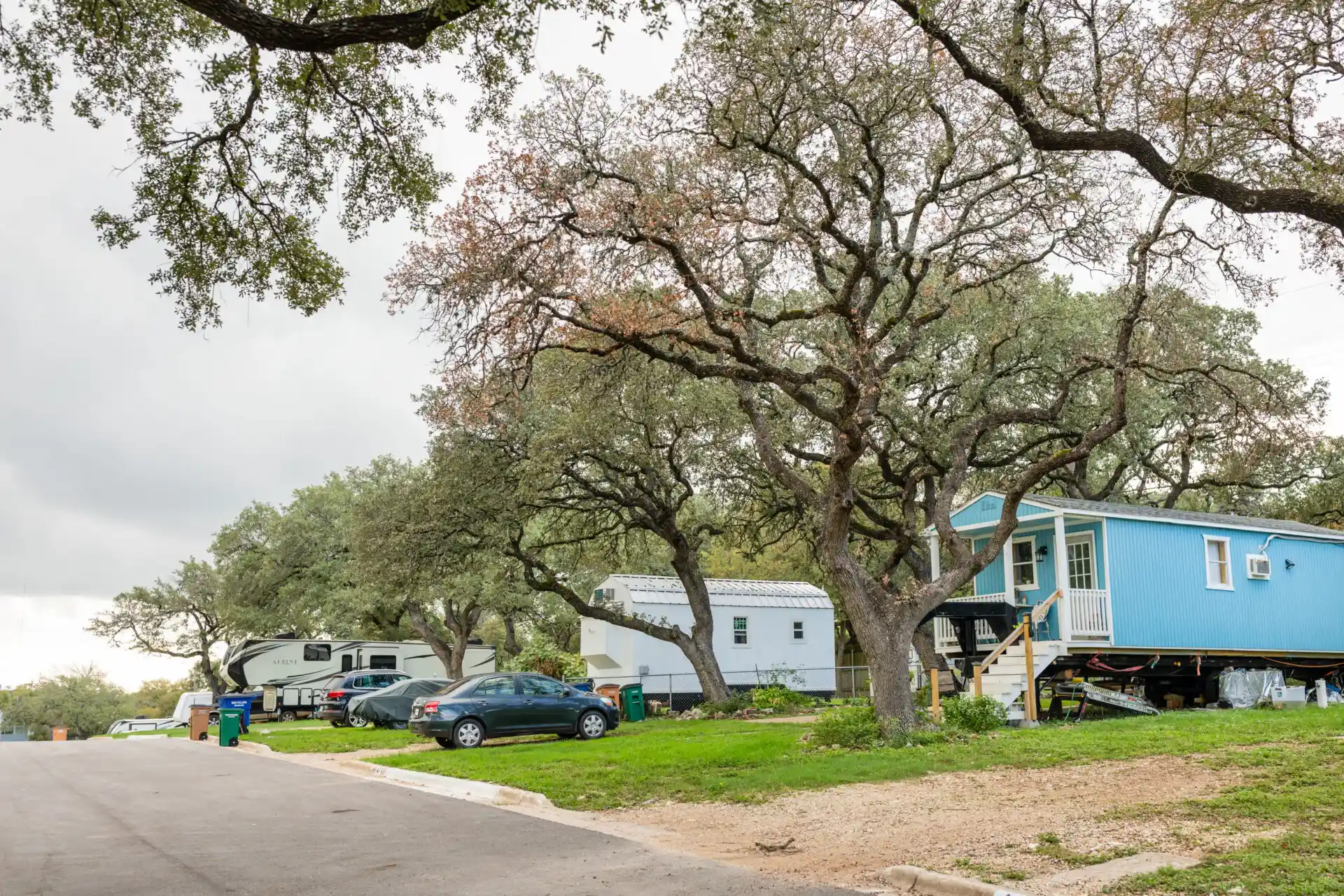 cars and moving homes in a park with trees